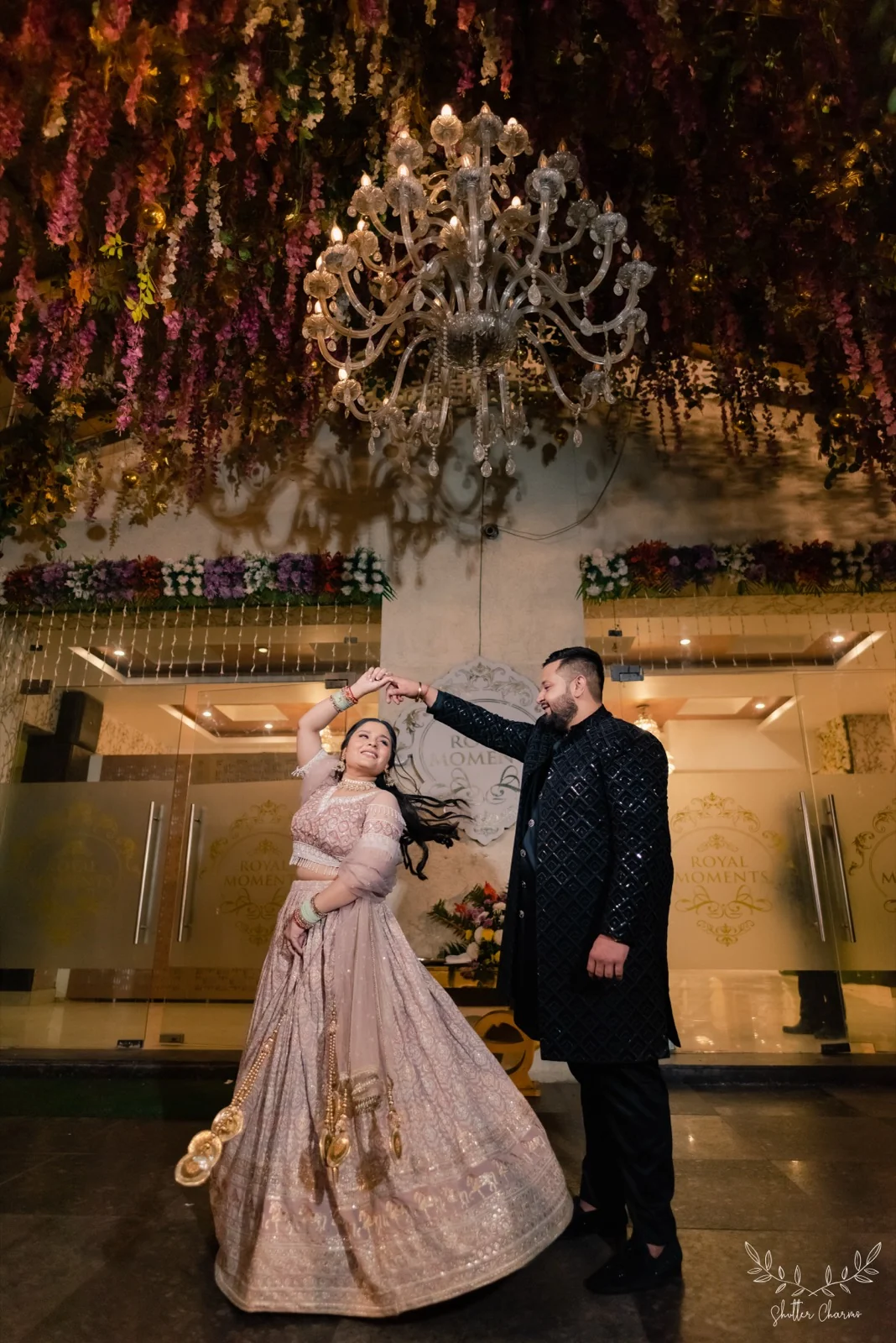 Couple dancing beneath a grand chandelier