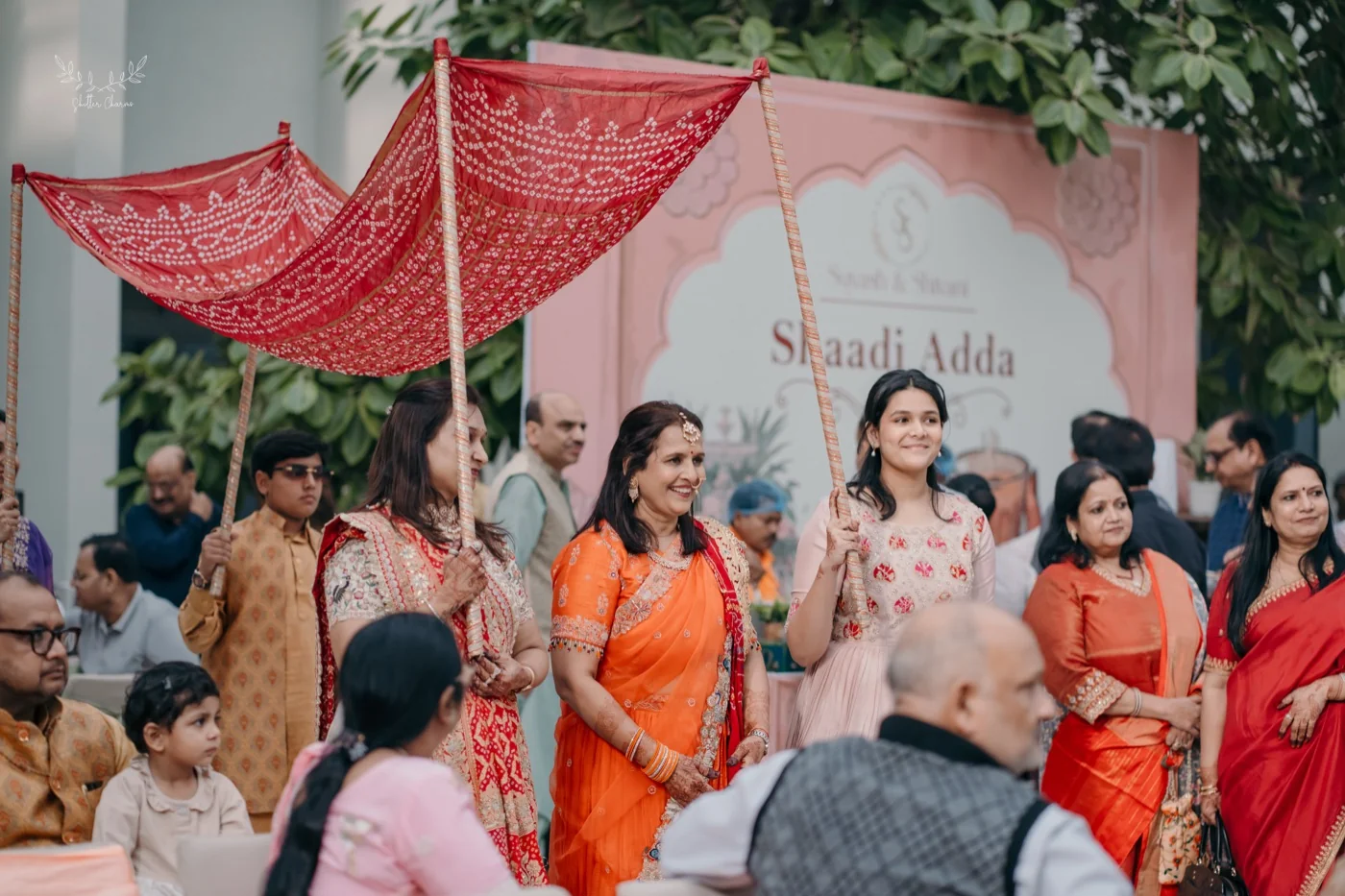 Bridal entry under a red embroidered canopy