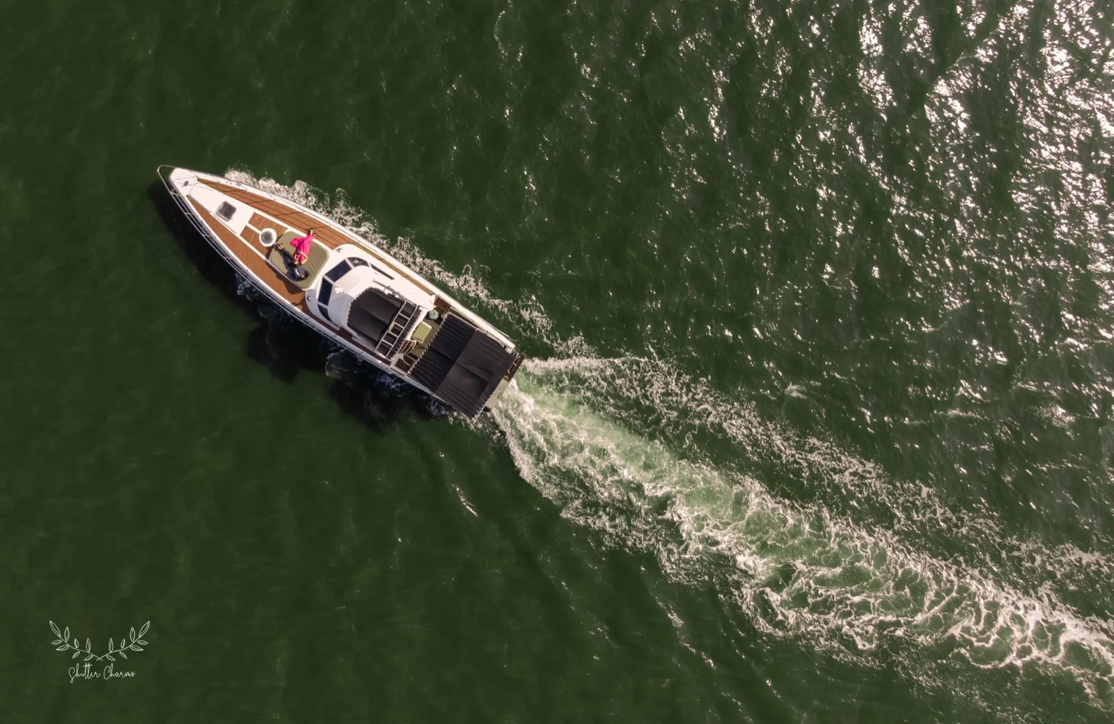 Aerial view of a couple relaxing on a yacht deck