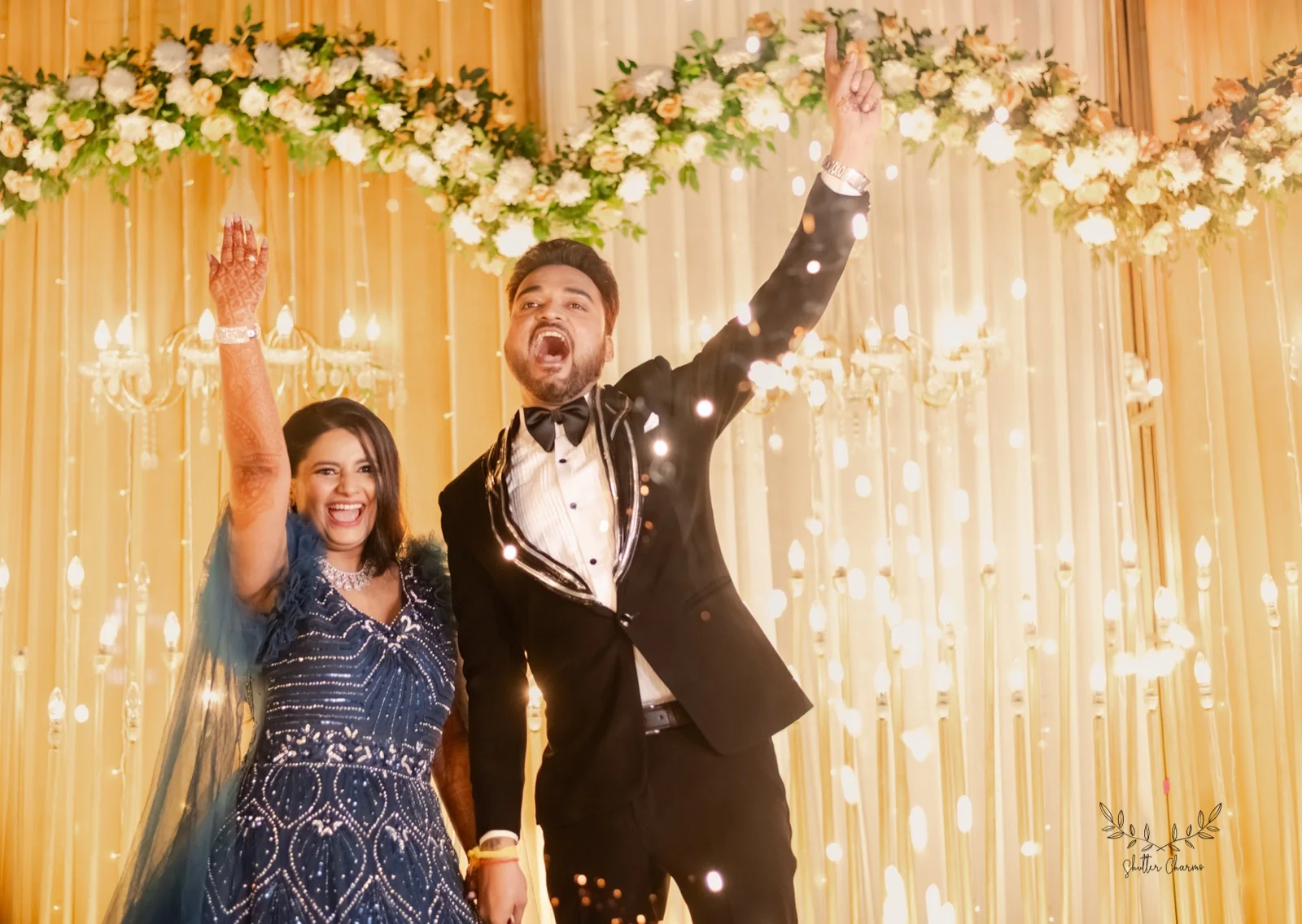 Couple cheering joyfully during their grand reception stage entry