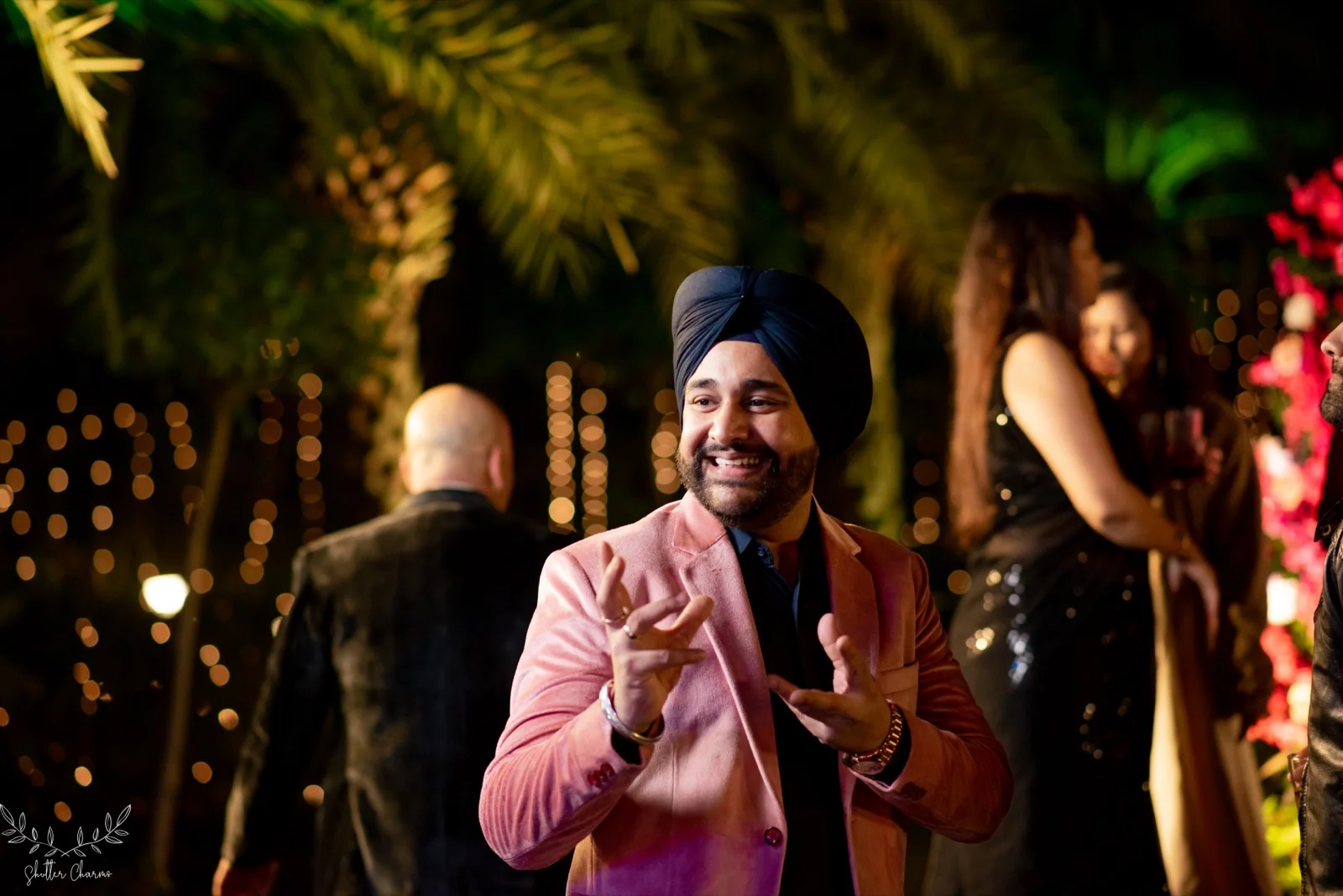 Guest in pink blazer enjoying the evening wedding festivities