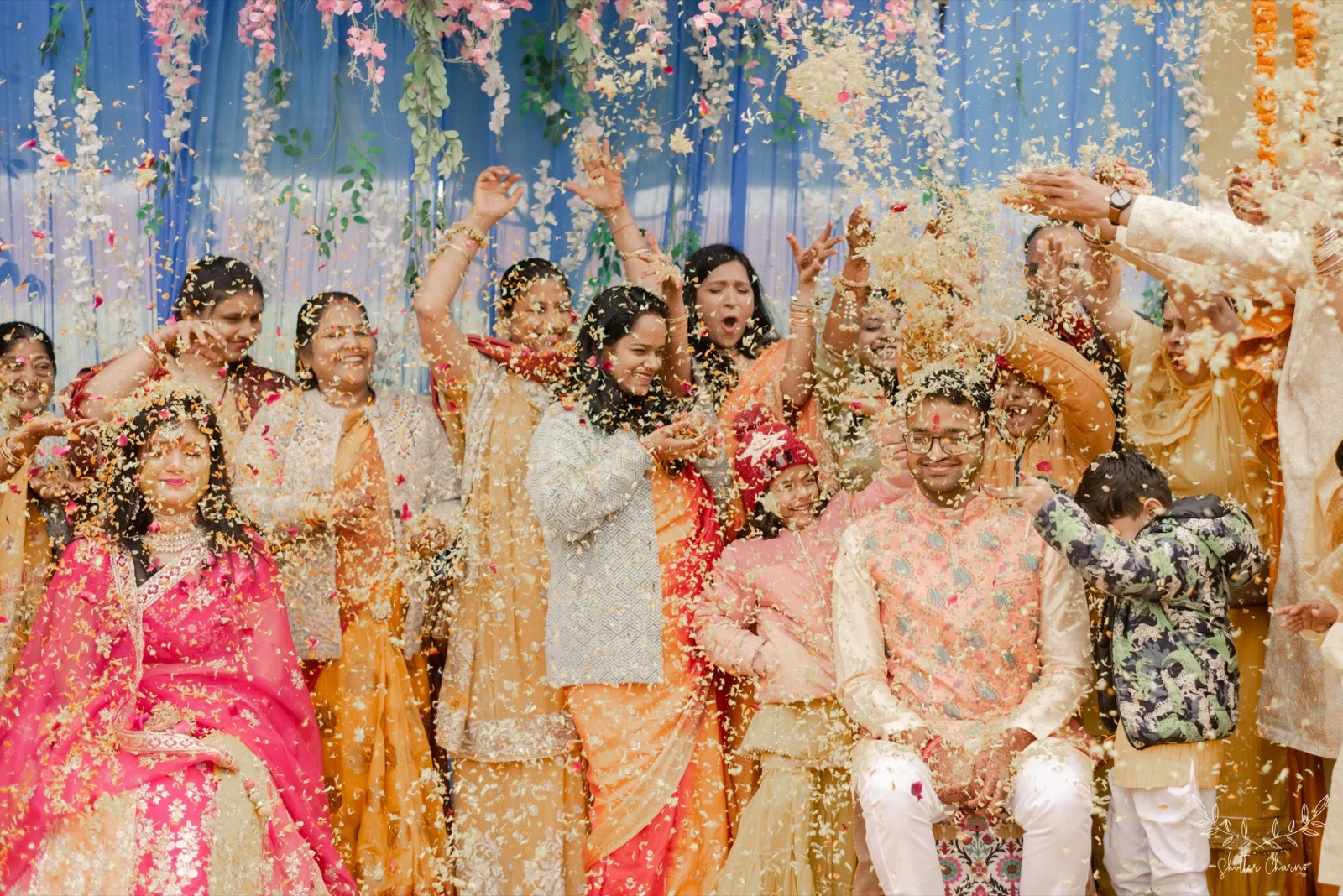 Guests showering flower petals over the smiling couple in celebration