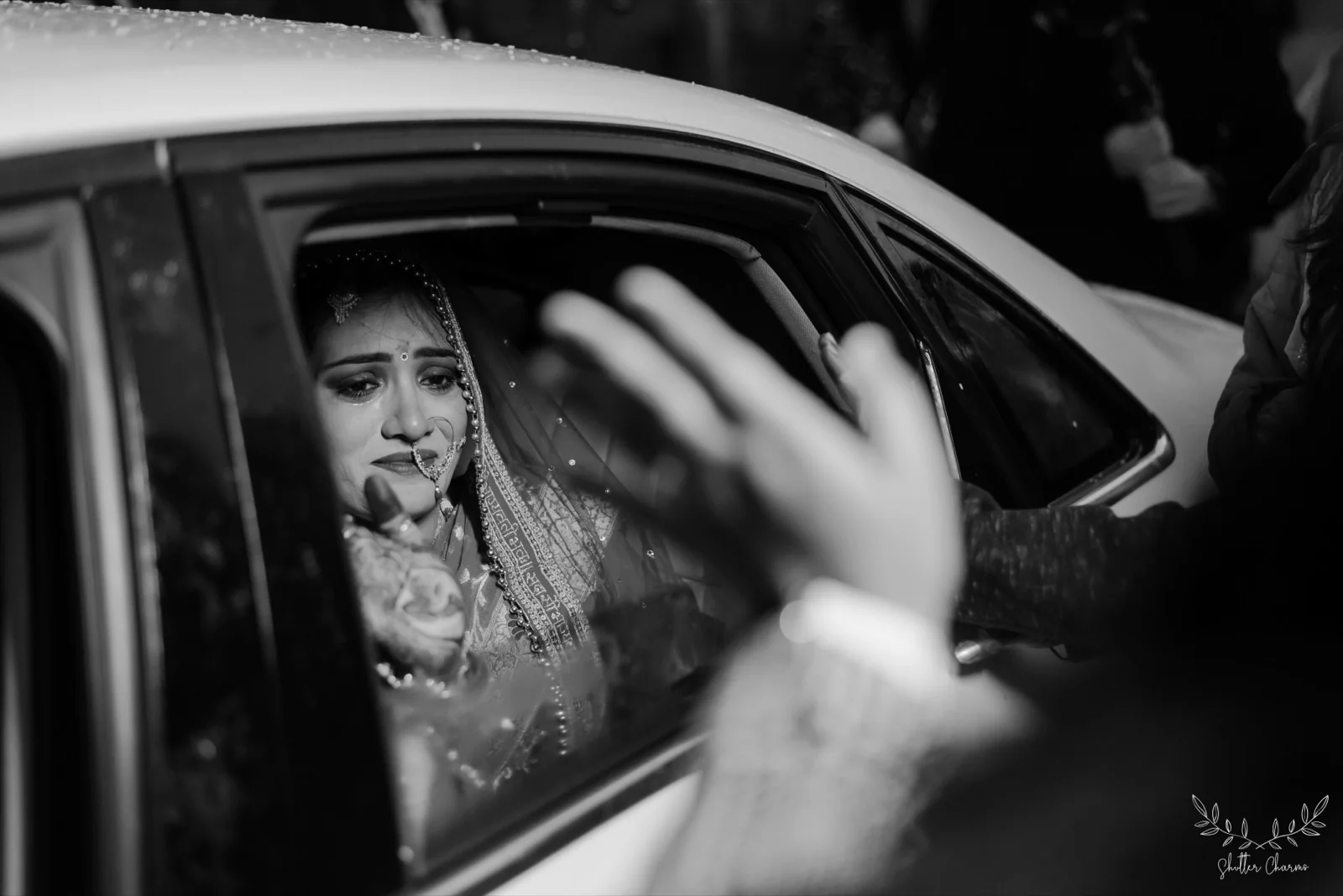 Emotional bride bidding farewell from the car during vidaai